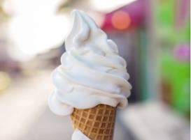 A person holding a plate of fruit cake